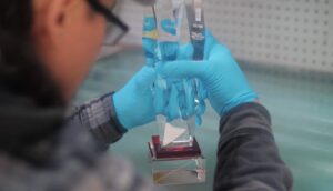 A production worker gluing up a crystal recognition award